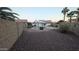 Spacious backyard with a sparkling pool, gravel landscaping, and privacy fencing, creating a serene oasis at 1044 N Arvada N --, Mesa, AZ 85205