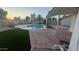 Inviting backyard features a refreshing pool, lush artificial turf, and ample patio space for outdoor enjoyment at 1044 N Arvada N --, Mesa, AZ 85205