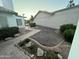 Well-maintained backyard featuring manicured landscaping, brick pathways, and desert-friendly plants at 1044 N Arvada N --, Mesa, AZ 85205