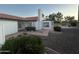 Expansive backyard with brick patio, desert plants, lush greenery, and a beautiful inground pool at 1044 N Arvada N --, Mesa, AZ 85205