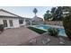 Inviting backyard featuring a refreshing pool, lush landscaping, and a covered patio for outdoor relaxation at 1044 N Arvada N --, Mesa, AZ 85205