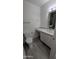 Bright bathroom with white cabinets, stone counters, and wood-look tile floors at 1044 N Arvada N --, Mesa, AZ 85205