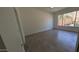 Bedroom with wood-look tile floors and view of landscaped yard at 1044 N Arvada N --, Mesa, AZ 85205