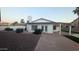 Charming home exterior with a well-maintained yard, featuring a covered patio and manicured landscaping at 1044 N Arvada N --, Mesa, AZ 85205
