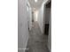 Hallway with tile flooring and white walls, leading to various rooms at 1044 N Arvada N --, Mesa, AZ 85205