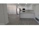 Open concept kitchen with white cabinets, updated appliances, and tile flooring at 1044 N Arvada N --, Mesa, AZ 85205