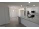 Contemporary kitchen with white cabinets, stainless steel appliances, and a spacious island at 1044 N Arvada N --, Mesa, AZ 85205