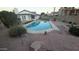 Stunning backyard oasis with a sparkling pool, gravel landscaping, and mature shrubs at 1044 N Arvada N --, Mesa, AZ 85205