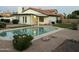 Relaxing backyard featuring a sparkling pool, desert landscaping, and a covered patio area at 1044 N Arvada N --, Mesa, AZ 85205