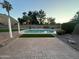 Inviting backyard with a refreshing swimming pool surrounded by manicured landscaping and brick pavers at 1044 N Arvada N --, Mesa, AZ 85205