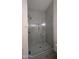 Close-up of a glass enclosed shower with gray tile surround and decorative lighting at 1044 N Arvada N --, Mesa, AZ 85205