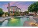 Resort-style backyard with large pool, covered patio, lounge chairs, and mature trees at 1073 N Layman St, Gilbert, AZ 85233