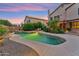 Large in-ground pool with baja step and lush landscaping at 1073 N Layman St, Gilbert, AZ 85233
