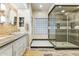 Spa-like bathroom with double sink, stone accents, and a large glass shower at 1073 N Layman St, Gilbert, AZ 85233