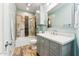 Bathroom features a vanity with marble countertop, modern fixtures, and stylish tile in the bathtub/shower area at 1073 N Layman St, Gilbert, AZ 85233