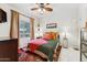 Comfortable bedroom features a ceiling fan, natural light, and colorful decor at 1073 N Layman St, Gilbert, AZ 85233