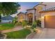Beautiful house exterior with landscaped yard, garden, lush greenery, and a two-car garage at 1073 N Layman St, Gilbert, AZ 85233