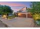 Inviting curb appeal with manicured lawn, mature tree and a spacious driveway leading to a three-car garage at 1073 N Layman St, Gilbert, AZ 85233
