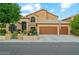 Charming two-story home featuring a three-car garage and well-manicured landscaping at 1073 N Layman St, Gilbert, AZ 85233