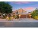 Well-manicured front lawn, lush landscaping, brick accents and a spacious driveway enhance the appeal of this home at 1073 N Layman St, Gilbert, AZ 85233