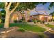 Charming home exterior featuring landscaped yard, garden, greenery, and a two-car garage at 1073 N Layman St, Gilbert, AZ 85233