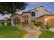 Lush green lawn, mature landscaping and custom paver walkway enhance the curb appeal of this beautiful home at 1073 N Layman St, Gilbert, AZ 85233