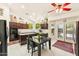 A spacious kitchen with a dining table, black appliances, and dark wood cabinets at 1073 N Layman St, Gilbert, AZ 85233