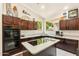 Bright kitchen with dark cabinets, white countertops, stainless steel appliances, and modern fixtures at 1073 N Layman St, Gilbert, AZ 85233