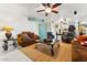 Spacious living room with ample seating, a ceiling fan, and a jute rug on tiled floor at 1073 N Layman St, Gilbert, AZ 85233