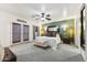 Bright main bedroom with a ceiling fan, carpet, and king size bed with a private entry at 1073 N Layman St, Gilbert, AZ 85233