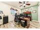 Bright office with a ceiling fan, window, green accent wall, and a well-equipped workspace at 1073 N Layman St, Gilbert, AZ 85233