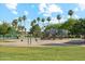 Community park featuring playground, tennis court, swing set, and mature trees at 1073 N Layman St, Gilbert, AZ 85233