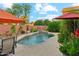 Inviting pool with lush landscaping, tranquil waterfall feature, and patio seating at 1073 N Layman St, Gilbert, AZ 85233