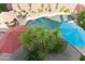 Aerial view of a backyard pool featuring lush landscaping and an outdoor seating area for entertaining at 1073 N Layman St, Gilbert, AZ 85233