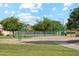 Community park featuring playground, tennis court, swing set, and mature trees at 1073 N Layman St, Gilbert, AZ 85233