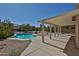 Covered patio overlooks backyard pool and desert landscaping, perfect for relaxing at 1114 S 220Th Ave, Buckeye, AZ 85326