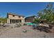 Backyard with in-ground pool, desert landscaping, and a covered patio at 1114 S 220Th Ave, Buckeye, AZ 85326
