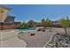 A sparkling pool sits amid desert landscaping in this tranquil backyard retreat at 1114 S 220Th Ave, Buckeye, AZ 85326