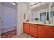 Bathroom featuring a vanity area with cabinet space and access to the tub and shower at 1114 S 220Th Ave, Buckeye, AZ 85326