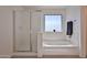 A bright bathroom with a large tub and separate shower at 1114 S 220Th Ave, Buckeye, AZ 85326
