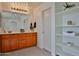 Bathroom with double sinks, wood cabinets, and a linen closet at 1114 S 220Th Ave, Buckeye, AZ 85326