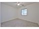 Bright bedroom featuring neutral carpet, a ceiling fan, and a window at 1114 S 220Th Ave, Buckeye, AZ 85326