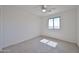 Bright bedroom featuring neutral carpet, a ceiling fan, and a window at 1114 S 220Th Ave, Buckeye, AZ 85326