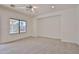 A spacious bedroom with a ceiling fan and window overlooking a covered patio at 1114 S 220Th Ave, Buckeye, AZ 85326