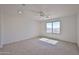 A carpeted bedroom with a ceiling fan, recessed lights, and a view to the outdoors at 1114 S 220Th Ave, Buckeye, AZ 85326