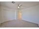Bright bedroom features neutral carpet, ceiling fan, closet, and fresh white paint at 1114 S 220Th Ave, Buckeye, AZ 85326