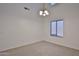 A bright dining room with carpet, a window, and a chandelier, perfect for gatherings at 1114 S 220Th Ave, Buckeye, AZ 85326