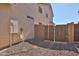 Exterior side of the house, showcasing utility access and backyard gate at 1114 S 220Th Ave, Buckeye, AZ 85326
