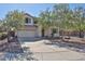 Charming two-story home featuring a well-manicured lawn, mature trees and a spacious two car garage at 1114 S 220Th Ave, Buckeye, AZ 85326
