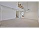 Expansive living room featuring vaulted ceilings, neutral decor, and staircase at 1114 S 220Th Ave, Buckeye, AZ 85326